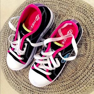 These are black Heelys in size 2Y.
